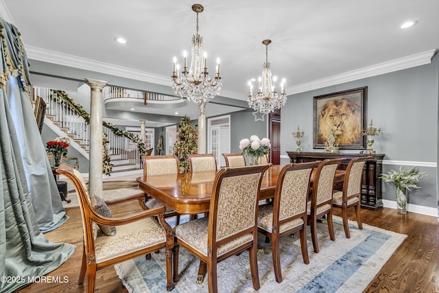 dining room with ornate columns, crown molding, dark hardwood / wood-style flooring, and a chandelier