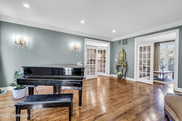 misc room featuring wood-type flooring, crown molding, and french doors