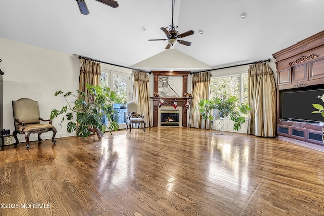 living room featuring hardwood / wood-style flooring, ceiling fan, a healthy amount of sunlight, and lofted ceiling