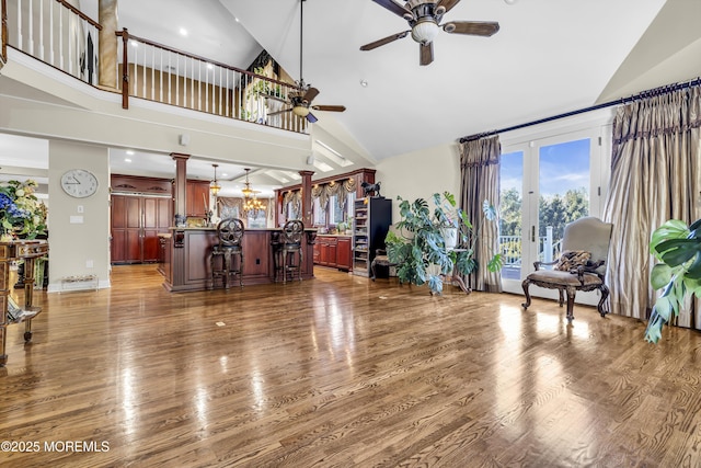 living room featuring ceiling fan, french doors, high vaulted ceiling, and dark wood-type flooring