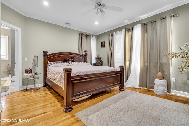 bedroom with wood-type flooring, ensuite bathroom, ceiling fan, and crown molding