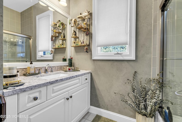 bathroom with tile patterned floors, vanity, and an enclosed shower