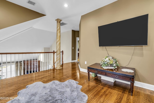 living room with hardwood / wood-style floors and decorative columns