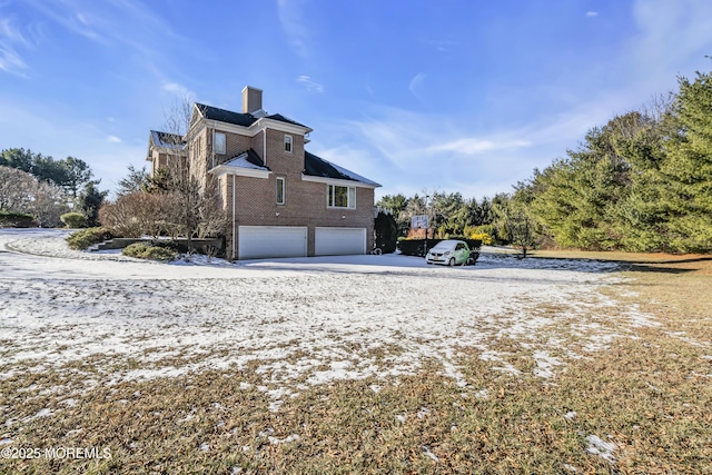 rear view of house with a garage