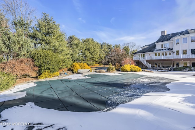 view of pool with a diving board and a patio