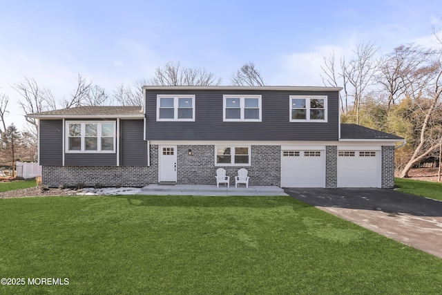 view of front facade with a front yard and a garage