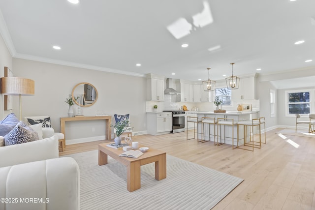 living room featuring ornamental molding and light wood-type flooring