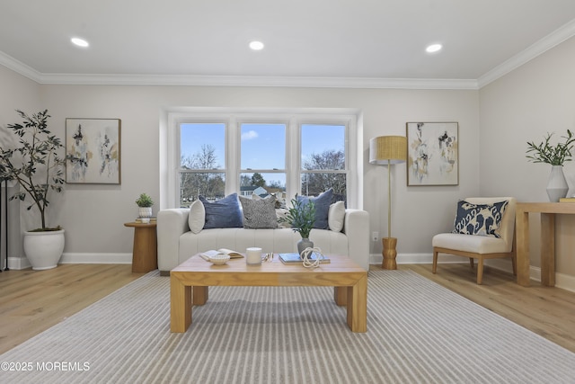 living room with light hardwood / wood-style floors and crown molding