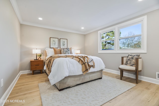 bedroom with light wood-type flooring and crown molding