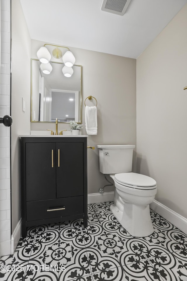 bathroom with tile patterned flooring, vanity, and toilet