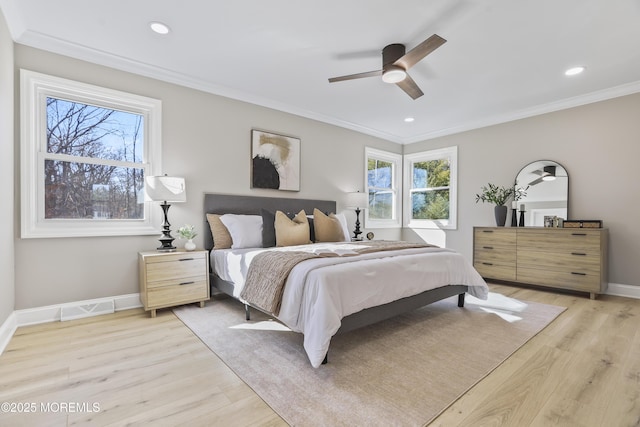 bedroom featuring ceiling fan, crown molding, and light wood-type flooring