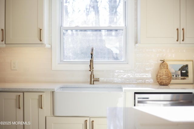 details with stainless steel dishwasher, backsplash, and sink