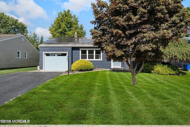 view of front of property with a front yard and solar panels