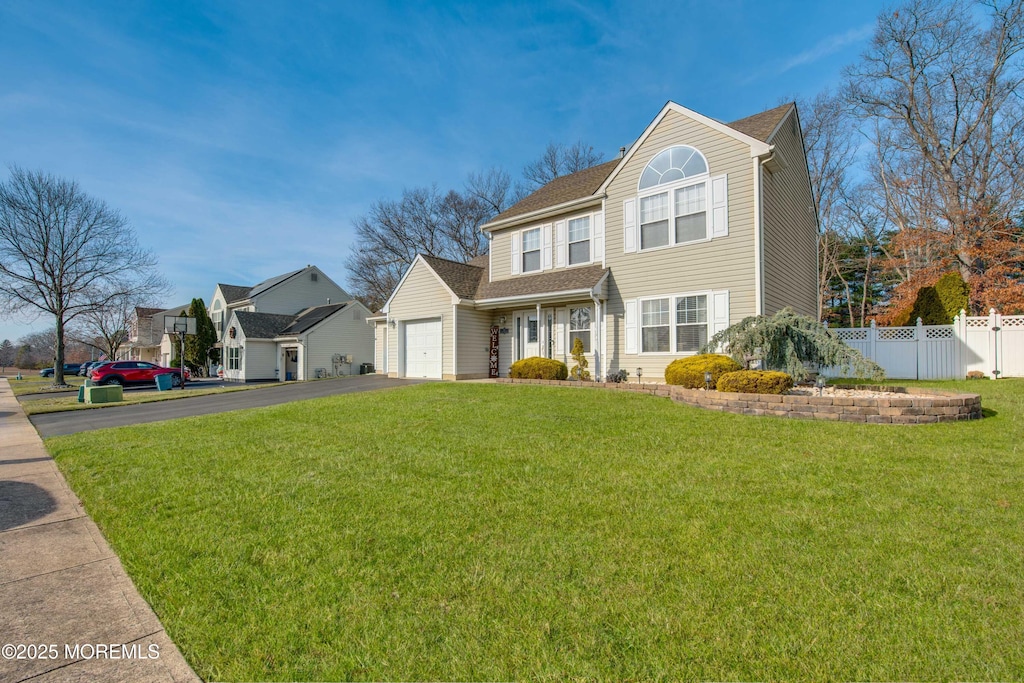 view of front of home with a front yard and a garage