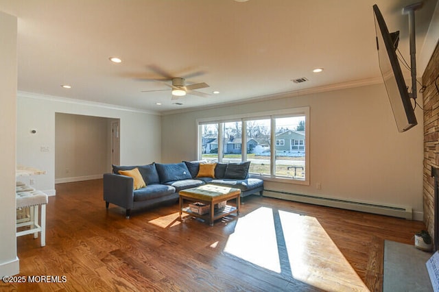 living area with ceiling fan, ornamental molding, wood finished floors, and a baseboard heating unit