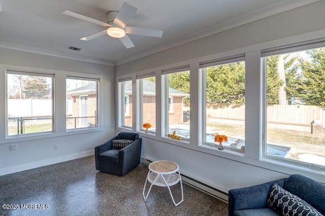 sunroom with visible vents, crown molding, baseboard heating, speckled floor, and baseboards