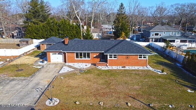 view of front facade featuring fence, a garage, and brick siding