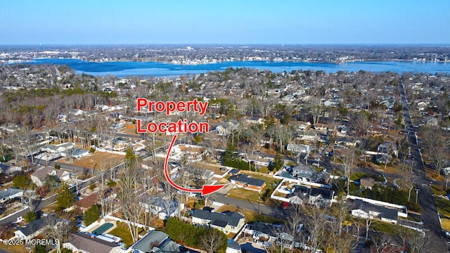 birds eye view of property with a water view and a residential view