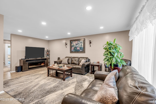 living room featuring a wealth of natural light and light hardwood / wood-style flooring