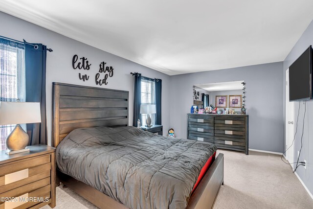 bedroom featuring light carpet