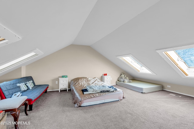 bedroom featuring carpet floors and lofted ceiling with skylight