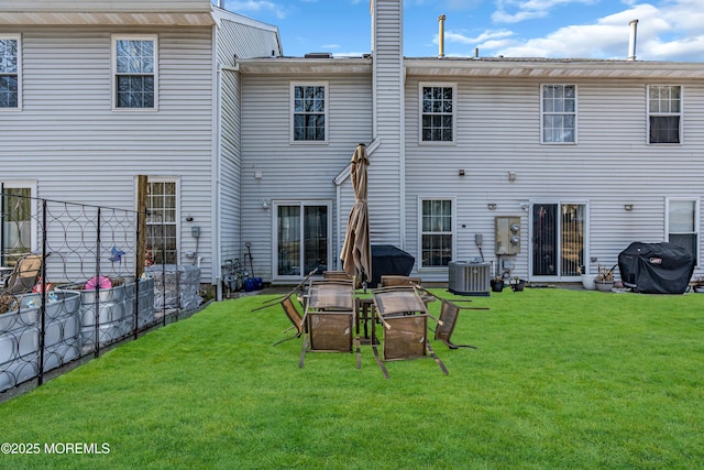 rear view of property with a lawn and central AC unit