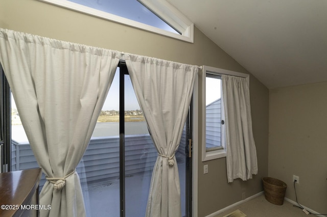 unfurnished bedroom featuring carpet floors and vaulted ceiling