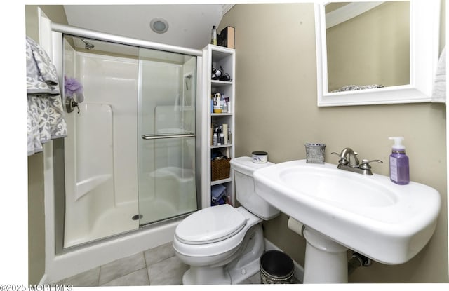 bathroom with toilet, a shower with door, tile patterned flooring, and sink