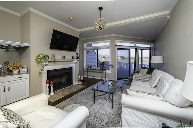 living room with dark wood-type flooring, french doors, crown molding, and a chandelier