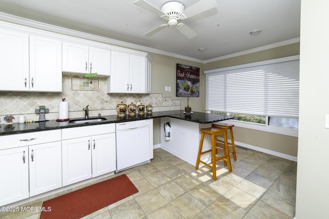 kitchen with kitchen peninsula, white dishwasher, ornamental molding, white cabinets, and sink