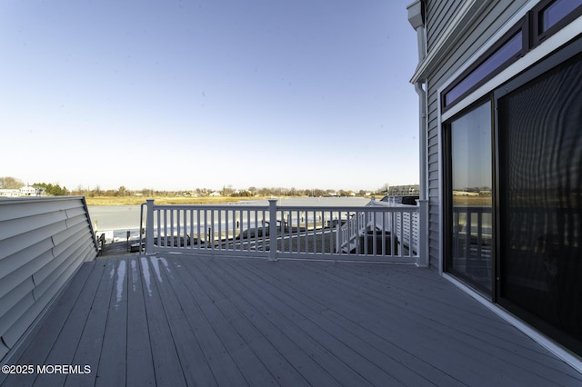 wooden deck with a water view