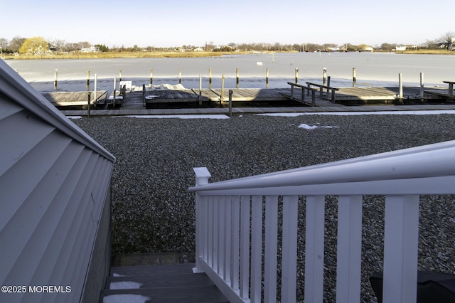 view of yard with a boat dock and a water view