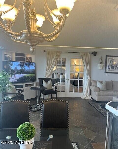 living room with french doors and crown molding