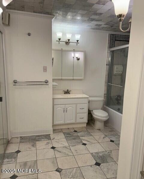 full bathroom with toilet, vanity, and combined bath / shower with glass door