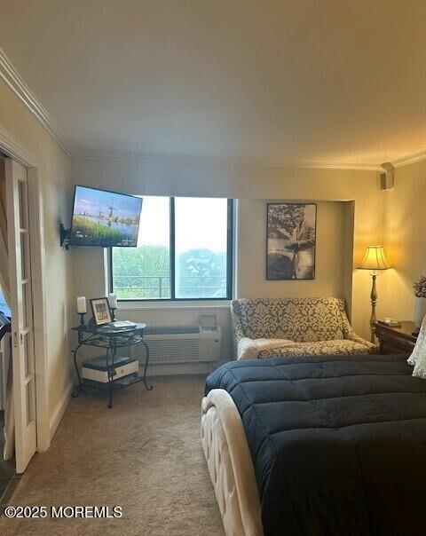 bedroom with crown molding and light carpet