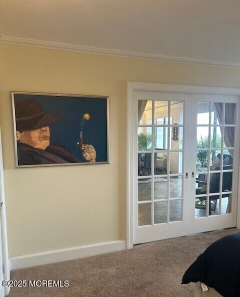 carpeted bedroom featuring french doors and crown molding