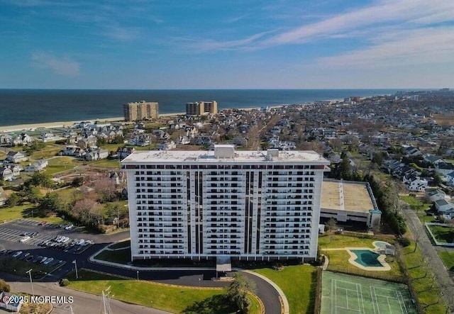 birds eye view of property with a view of city and a water view