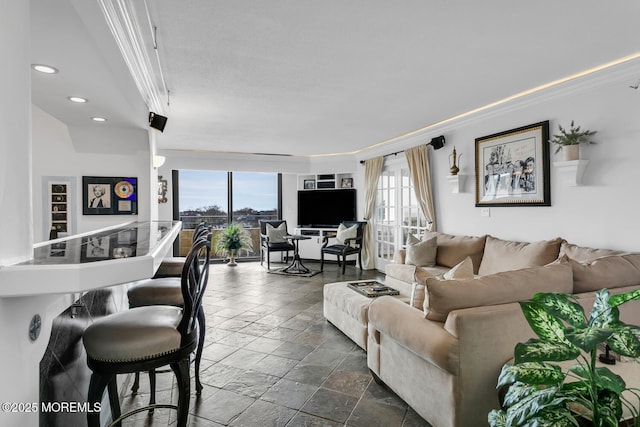 living area with crown molding, recessed lighting, plenty of natural light, and stone tile floors