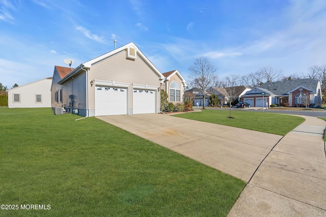 view of front of house with cooling unit, a garage, and a front yard