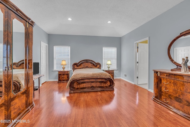 bedroom featuring a textured ceiling and light wood-type flooring