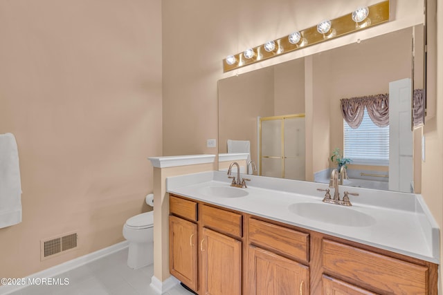 bathroom with tile patterned flooring, toilet, a shower with door, and vanity