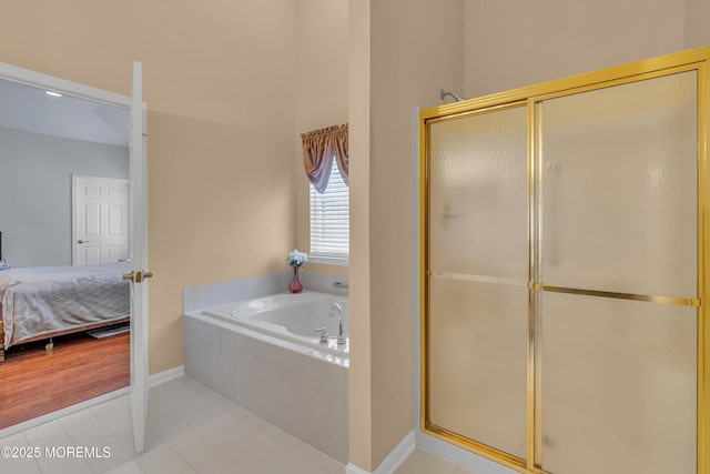 bathroom with tile patterned flooring and separate shower and tub