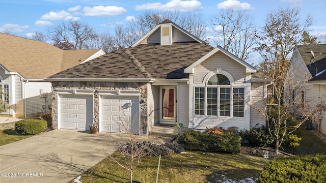 view of front of property featuring a garage and a front lawn