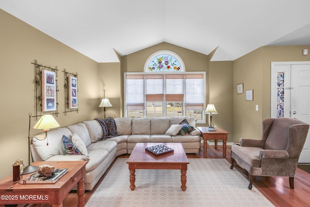 living room featuring vaulted ceiling and hardwood / wood-style flooring