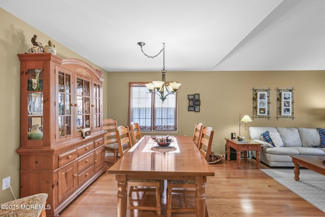 dining room featuring light hardwood / wood-style flooring and an inviting chandelier