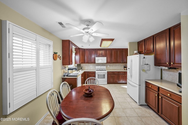 kitchen with white appliances, ceiling fan, and backsplash