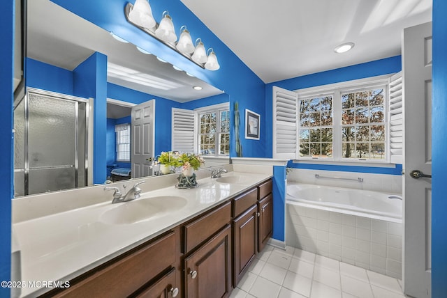 bathroom with tile patterned flooring, plus walk in shower, and vanity