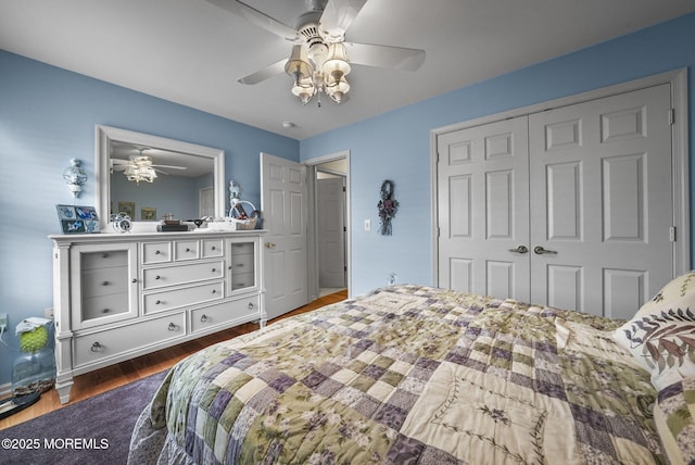 bedroom with dark hardwood / wood-style flooring, a closet, and ceiling fan