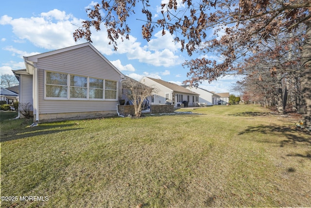 back of house with a lawn