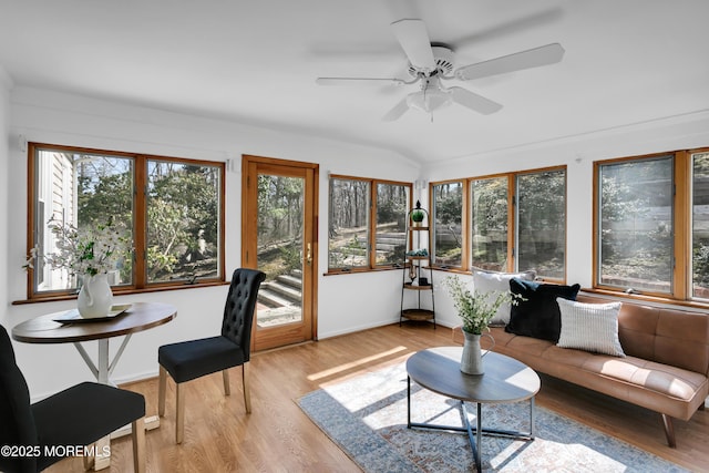 sunroom featuring vaulted ceiling and a ceiling fan